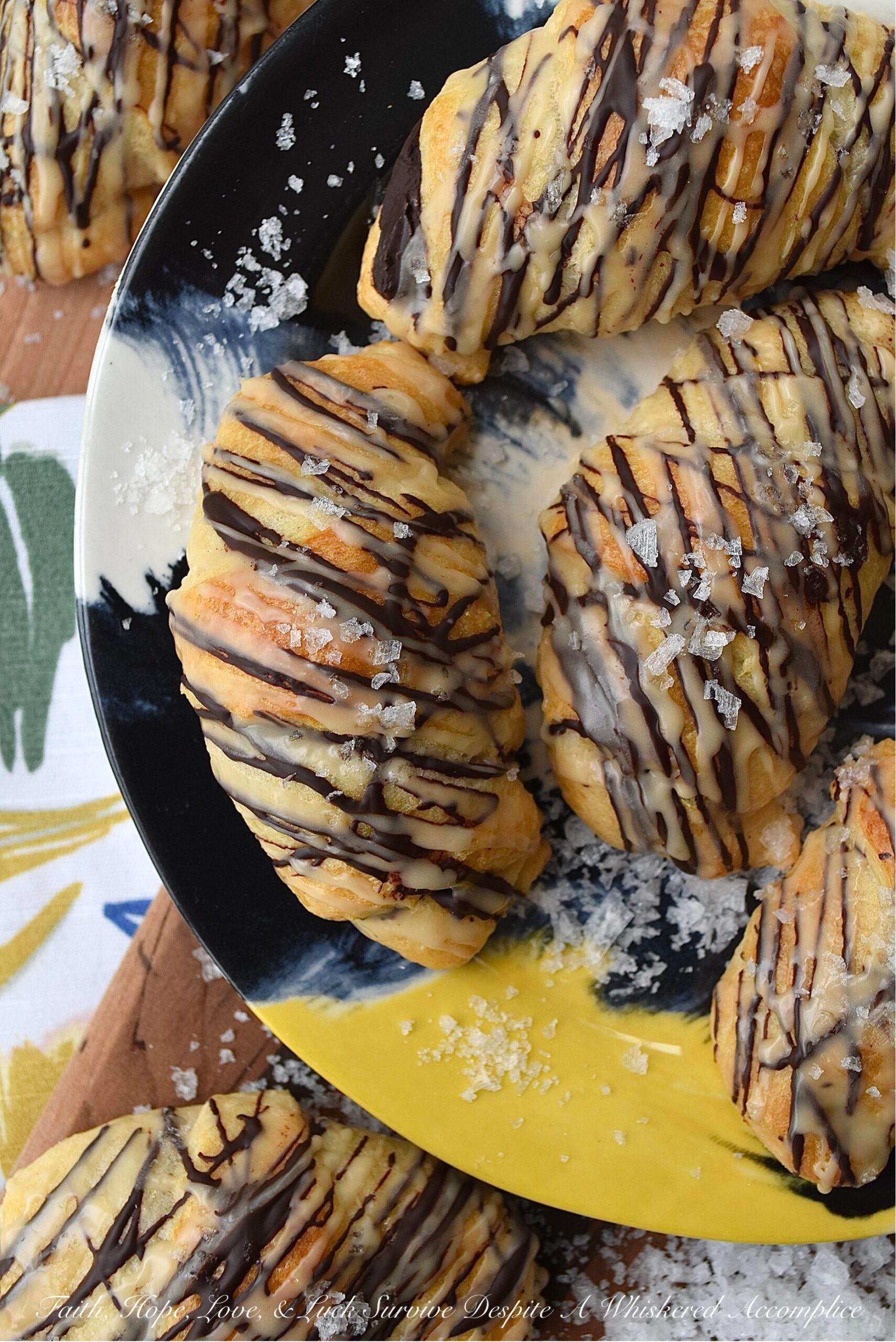Chocolate Crescent Rolls with Baileys & Sea Salt - When you wake up and find yourself in need of a sweet treat but don't feel like spending all morning in the kitchen, these chocolate crescent rolls are just what you need. Store-bought crescent rolls are filled with chopped chocolate, baked until golden brown, and then drizzled with both additional melted chocolate and a sweet Baileys Irish Cream glaze. A little sprinkle of sea salt is the final and flavorful touch to help make this breakfast, brunch, or dessert treat simply irresistible.