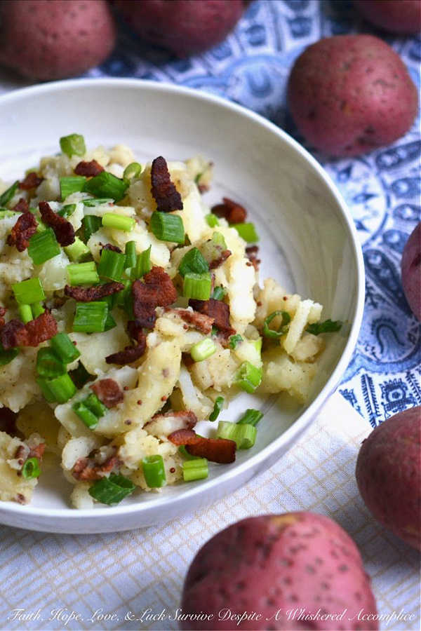 Hot German Potato Salad with Bacon - This hot potato salad is given a sweet and tangy German twist by using a simple Dijon and whole grain mustard vinaigrette along with crispy crumbled bacon. If you're searching for a no-mayonnaise side dish recipe for your next barbecue or cookout, this German potato salad is a great option.