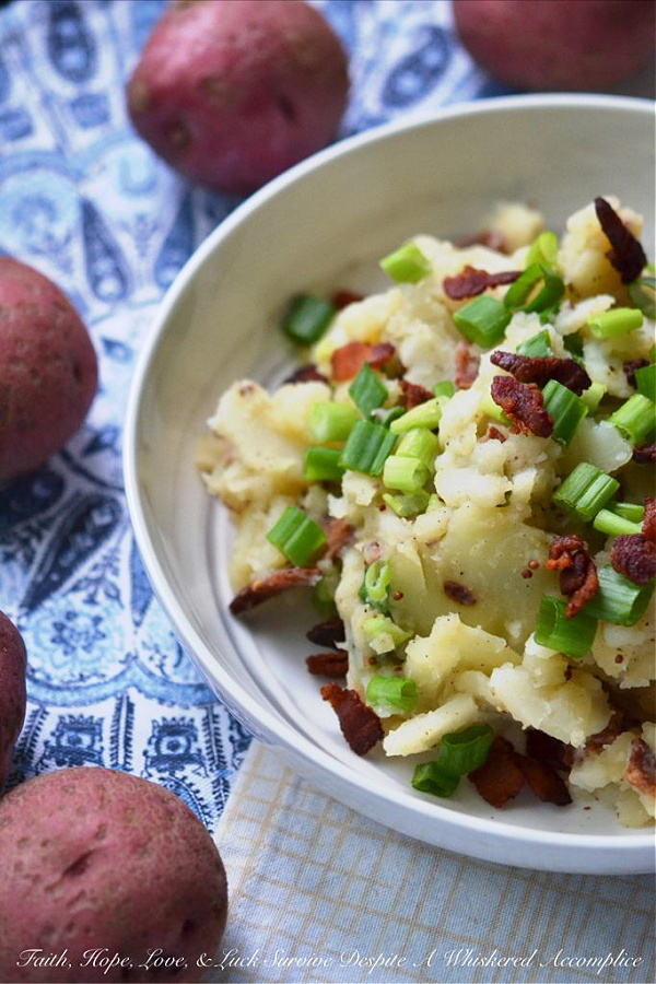 Hot German Potato Salad with Bacon - This hot potato salad is given a sweet and tangy German twist by using a simple Dijon and whole grain mustard vinaigrette along with crispy crumbled bacon. If you're searching for a no-mayonnaise side dish recipe for your next barbecue or cookout, this German potato salad is a great option.