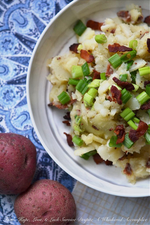 Hot German Potato Salad with Bacon - This hot potato salad is given a sweet and tangy German twist by using a simple Dijon and whole grain mustard vinaigrette along with crispy crumbled bacon. If you're searching for a no-mayonnaise side dish recipe for your next barbecue or cookout, this German potato salad is a great option.