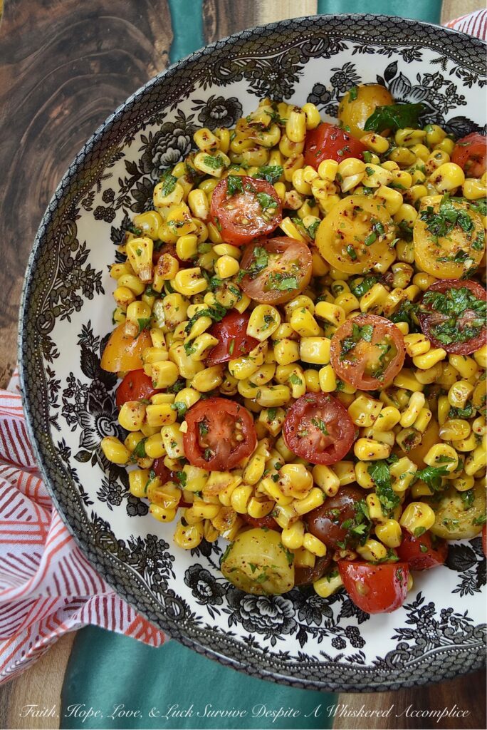 Corn & Tomato Salad with Hot Honey Vinaigrette - This bright and colorful corn and tomato salad is the perfect side dish for almost any busy weeknight dinner, impromptu cookout, or last-minute barbecue. Simply microwave a bag of steam-in-bag corn kernels, halve some cherry tomatoes, and mix the steamed corn and halved tomatoes in an easy-to-make vinaigrette, made with chili-infused hot honey, finely chopped fresh parsley, and a few common pantry seasonings.