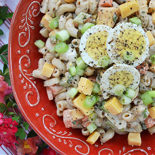 BBQ Cheddar Summer Macaroni Salad - Favorite Summertime Pasta Salad Recipes - What would summertime be without an enormous bowl of creamy homemade pasta salad? They're easy to make, can be made for almost any sized crowd, taste so much better than store-bought, and can be made to fit almost any budget. Here, you'll find some of our favorite summer macaroni, tortellini, and couscous pasta salad recipes, just perfect for your next cookout, picnic, reunion, pool party, or barbeque get-together.
