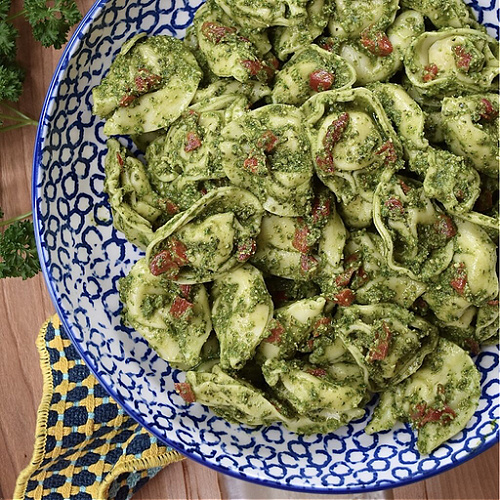 Cheese Tortellini with Nut-Free Pesto & Pimentos - Favorite Summertime Pasta Salad Recipes - What would summertime be without an enormous bowl of creamy homemade pasta salad? They're easy to make, can be made for almost any sized crowd, taste so much better than store-bought, and can be made to fit almost any budget. Here, you'll find some of our favorite summer macaroni, tortellini, and couscous pasta salad recipes, just perfect for your next cookout, picnic, reunion, pool party, or barbeque get-together.