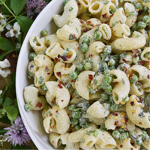 Green Pea & Herb Macaroni Salad - Favorite Summertime Pasta Salad Recipes - What would summertime be without an enormous bowl of creamy homemade pasta salad? They're easy to make, can be made for almost any sized crowd, taste so much better than store-bought, and can be made to fit almost any budget. Here, you'll find some of our favorite summer macaroni, tortellini, and couscous pasta salad recipes, just perfect for your next cookout, picnic, reunion, pool party, or barbeque get-together.