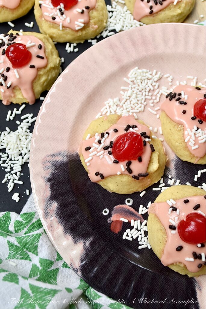 Amish Buttermilk Vanilla Sundae Cookies - These buttermilk Amish cookies are soft, dreamy, flecked with vanilla bean seeds, and covered in a sweet, creamy, decadent cherry juice and vanilla-infused icing. To create charmingly adorable and irresistible cakey sundae cookies no one can resist, simply sprinkle on a few sprinkles and top with half a maraschino cherry.