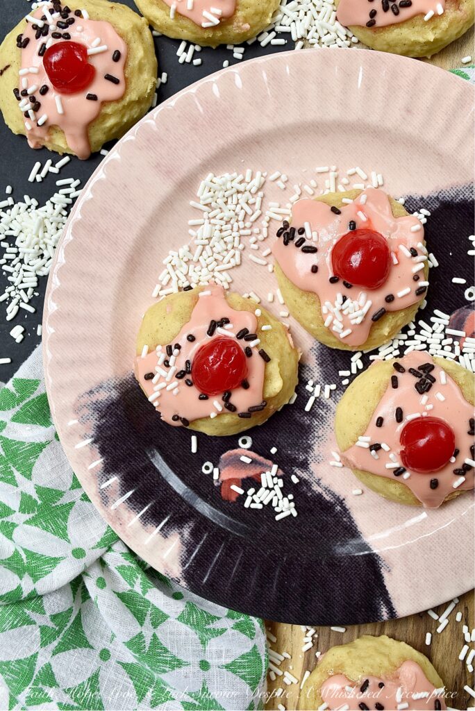 Amish Buttermilk Vanilla Sundae Cookies - These buttermilk Amish cookies are soft, dreamy, flecked with vanilla bean seeds, and covered in a sweet, creamy, decadent cherry juice and vanilla-infused icing. To create charmingly adorable and irresistible cakey sundae cookies no one can resist, simply sprinkle on a few sprinkles and top with half a maraschino cherry.