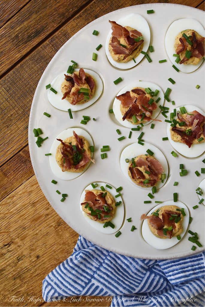 Honey BBQ Seasoned Deviled Eggs with Bacon - These honey barbeque-seasoned deviled eggs with bacon are a must-try. With a touch of honey and the perfect amount of homemade BBQ seasoning, these deviled eggs are a sweet and flavorful addition to almost any meal. And, the crispy bacon and fresh chives that these eggs are garnished with add a nice touch of crunch and freshness to each and every bite. Whether you're serving these as an appetizer or a side dish, this deviled egg recipe is sure to be a crowd-pleaser.