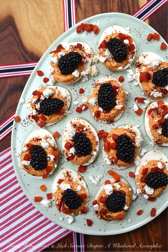 Red, White, & Blue Sweet Pimento Deviled Eggs - These red, white, & blue deviled eggs are the perfect appetizer for your next July 4th celebration. The savory sweetness of the creamy pimento and feta egg filling really helps make this non-traditional deviled egg recipe stand out. And, after these heavenly deviled eggs are garnished with chili powder, pimentos, feta, and perfectly ripe blackberries, they'll be just as gorgeous as they are delicious.
