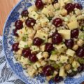 Couscous Salad with Gouda & Fresh Cherries - Ditch your traditional pasta salad recipe and switch things up for once with this colorful, fresh, and flavorful couscous salad. This unique pearl or Israeli couscous side dish uses fresh cherries, cubed gouda, canned chickpeas, and a fresh basil vinaigrette to add lots of bold and bright flavors.