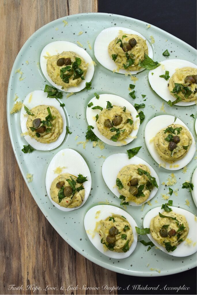 Deviled Eggs with Basil, Capers, & Lemon Zest - If you're looking to impress your guests with a delicious and unique appetizer, you can't go wrong with these deviled eggs. With the addition of fresh basil, capers, and lemon zest, they're sure to be the hit of the party. They're refreshing and have a hint of salt, with a touch of herby goodness that makes them simply irresistible. Your guests will be begging for the recipe.