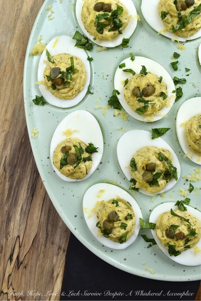 Deviled Eggs with Basil, Capers, & Lemon Zest - If you're looking to impress your guests with a delicious and unique appetizer, you can't go wrong with these deviled eggs. With the addition of fresh basil, capers, and lemon zest, they're sure to be the hit of the party. They're refreshing and have a hint of salt, with a touch of herby goodness that makes them simply irresistible. Your guests will be begging for the recipe.