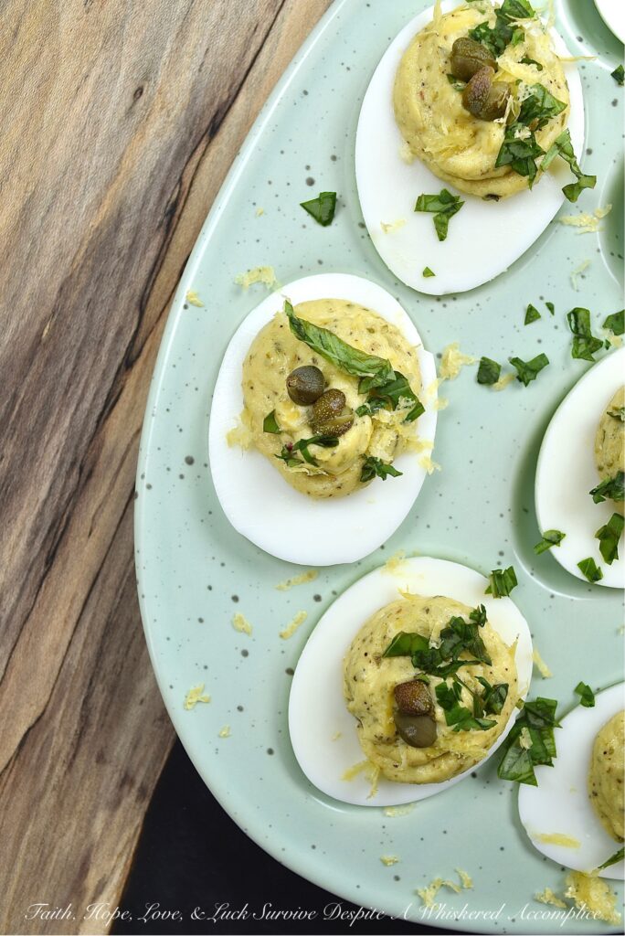 Deviled Eggs with Basil, Capers, & Lemon Zest - If you're looking to impress your guests with a delicious and unique appetizer, you can't go wrong with these deviled eggs. With the addition of fresh basil, capers, and lemon zest, they're sure to be the hit of the party. They're refreshing and have a hint of salt, with a touch of herby goodness that makes them simply irresistible. Your guests will be begging for the recipe.