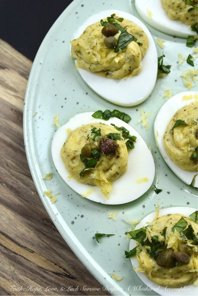 Deviled Eggs with Basil, Capers, & Lemon Zest - If you're looking to impress your guests with a delicious and unique appetizer, you can't go wrong with these deviled eggs. With the addition of fresh basil, capers, and lemon zest, they're sure to be the hit of the party. They're refreshing and have a hint of salt, with a touch of herby goodness that makes them simply irresistible. Your guests will be begging for the recipe.