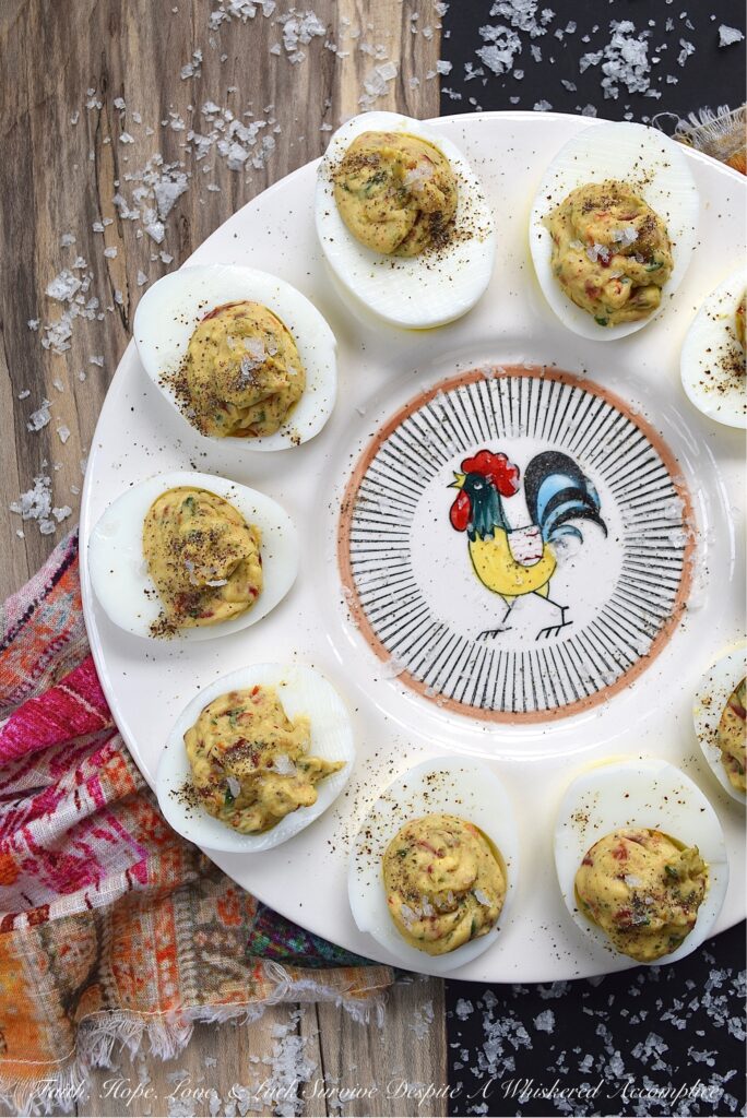 Fresh Basil & Sun-Dried Tomato Deviled Eggs - Fresh basil is the key ingredient to this simple yet extraordinary deviled egg recipe. When paired with very finely chopped sun-dried tomatoes, it immediately helps to make a winning impression on anyone lucky enough to scarf down one of these eggs before they all disappear. And yes, they will all disappear pretty quickly, so perhaps you might want to consider making a double batch.