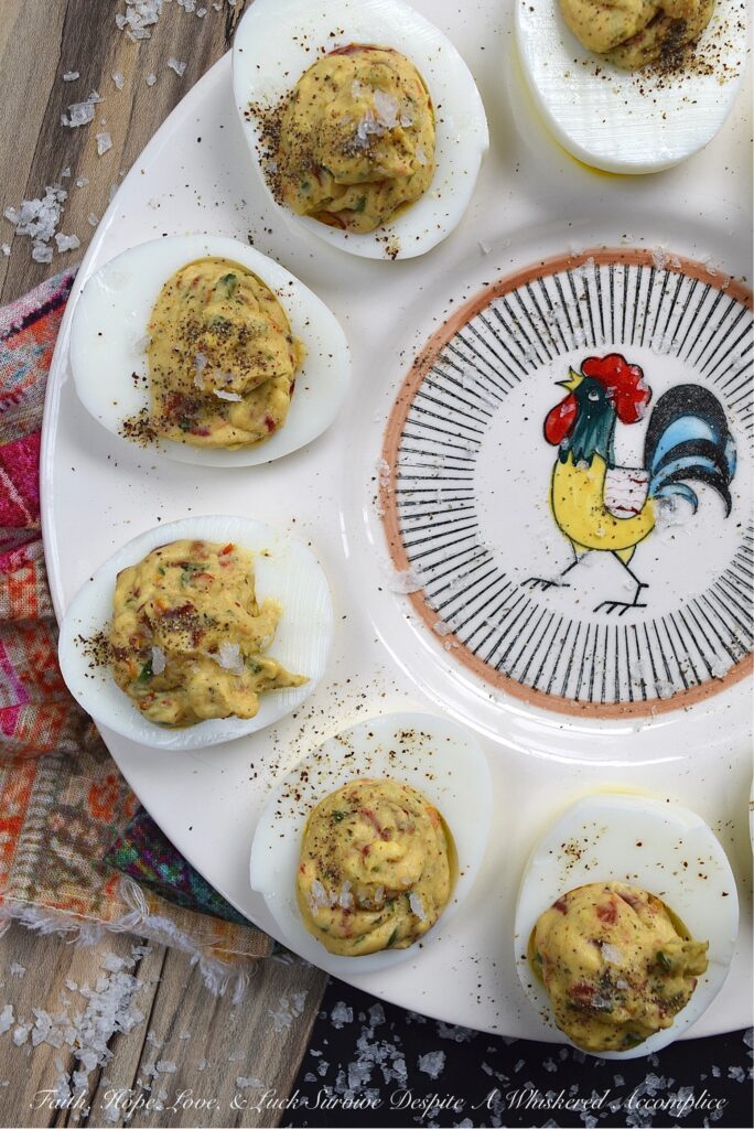 Fresh Basil & Sun-Dried Tomato Deviled Eggs - Fresh basil is the key ingredient to this simple yet extraordinary deviled egg recipe. When paired with very finely chopped sun-dried tomatoes, it immediately helps to make a winning impression on anyone lucky enough to scarf down one of these eggs before they all disappear. And yes, they will all disappear pretty quickly, so perhaps you might want to consider making a double batch.