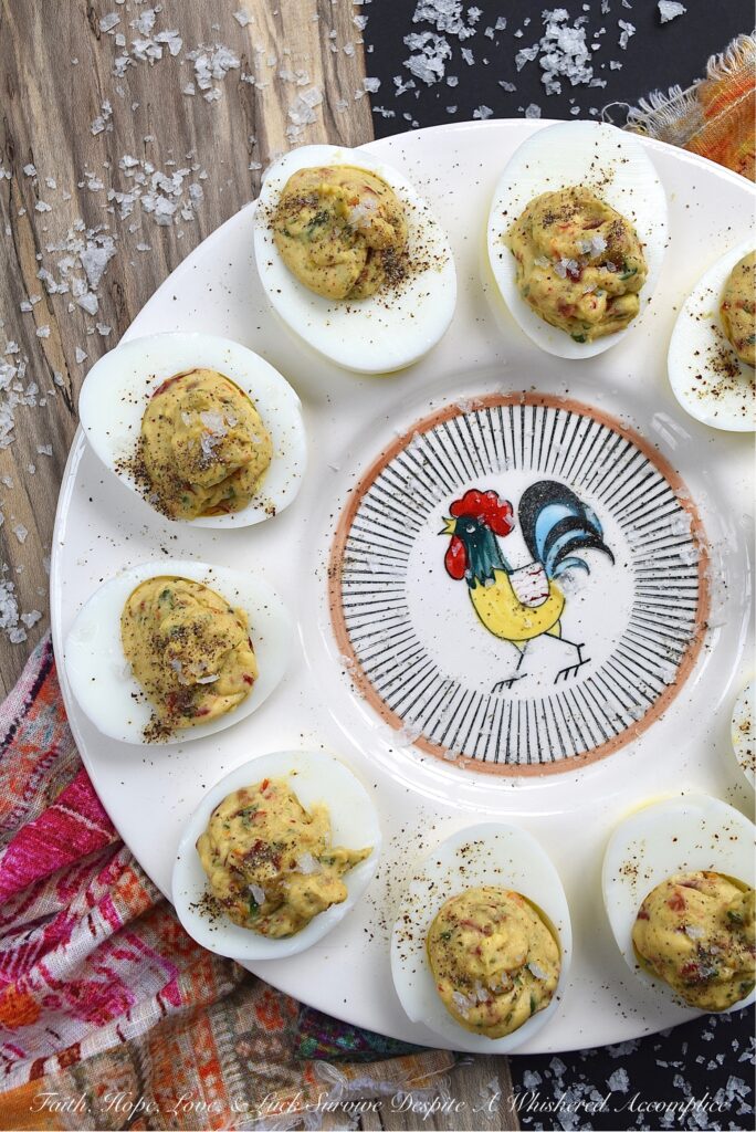 Fresh Basil & Sun-Dried Tomato Deviled Eggs - Fresh basil is the key ingredient to this simple yet extraordinary deviled egg recipe. When paired with very finely chopped sun-dried tomatoes, it immediately helps to make a winning impression on anyone lucky enough to scarf down one of these eggs before they all disappear. And yes, they will all disappear pretty quickly, so perhaps you might want to consider making a double batch.