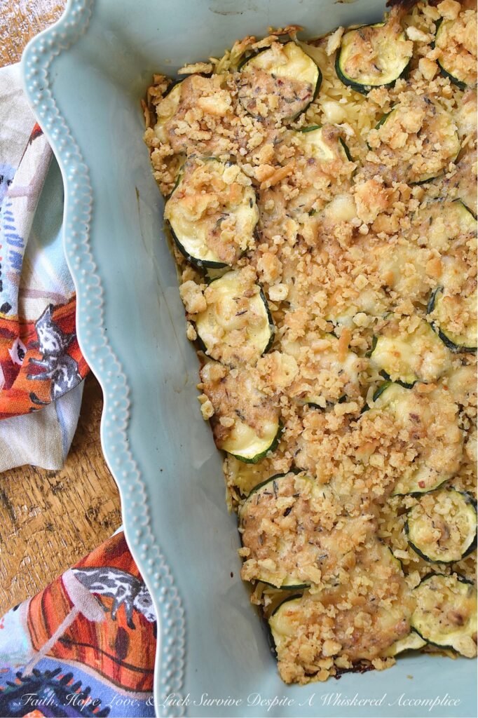 Zucchini & Orzo Pasta Baked Cheddar Casserole - This layered summer zucchini baked casserole with orzo pasta and cheddar cheese is a savory and delicious easy-to-make summer side dish. It's perfect for using up any extra zucchini you have from your garden, and it's a great crowd-pleaser for the whole family. The layers of pasta, zucchini, creamy sauce, and cheddar cheese make for a flavorful and satisfying dish. And to top it off, there's a crunchy butter cracker topping that adds just the right amount of texture to this tender zucchini and pasta baked casserole.