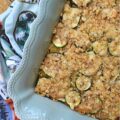 Zucchini & Orzo Pasta Baked Cheddar Casserole - This layered summer zucchini baked casserole with orzo pasta and cheddar cheese is a savory and delicious easy-to-make summer side dish. It's perfect for using up any extra zucchini you have from your garden, and it's a great crowd-pleaser for the whole family. The layers of pasta, zucchini, creamy sauce, and cheddar cheese make for a flavorful and satisfying dish. And to top it off, there's a crunchy butter cracker topping that adds just the right amount of texture to this tender zucchini and pasta baked casserole.