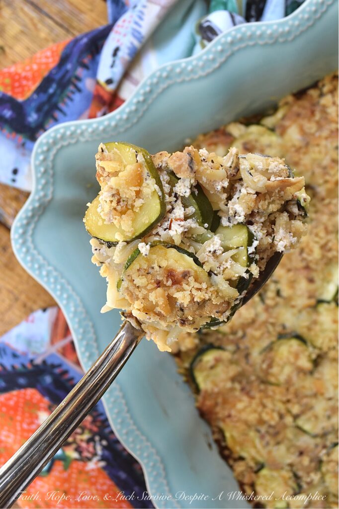 Zucchini & Orzo Pasta Baked Cheddar Casserole - This layered summer zucchini baked casserole with orzo pasta and cheddar cheese is a savory and delicious easy-to-make summer side dish. It's perfect for using up any extra zucchini you have from your garden, and it's a great crowd-pleaser for the whole family. The layers of pasta, zucchini, creamy sauce, and cheddar cheese make for a flavorful and satisfying dish. And to top it off, there's a crunchy butter cracker topping that adds just the right amount of texture to this tender zucchini and pasta baked casserole.