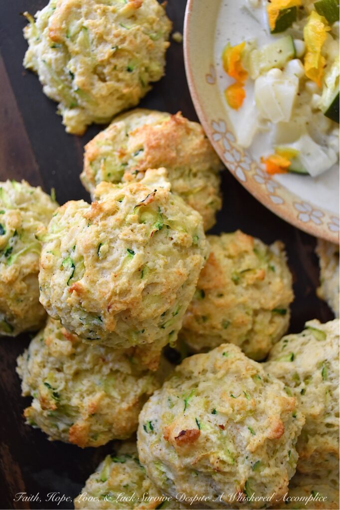 Savory Zucchini Drop Biscuits - With zucchini in season, these buttery, easy-to-make drop biscuits make a delicious addition to any summer meal. The result is a delicious, light, and savory biscuit that pairs perfectly with various dishes. Serve them as a side to your favorite summer soups or salads, or enjoy them as a snack with a pat of rich creamy butter. Whatever way you choose, savory zucchini drop biscuits will make your summer meals all the more special.