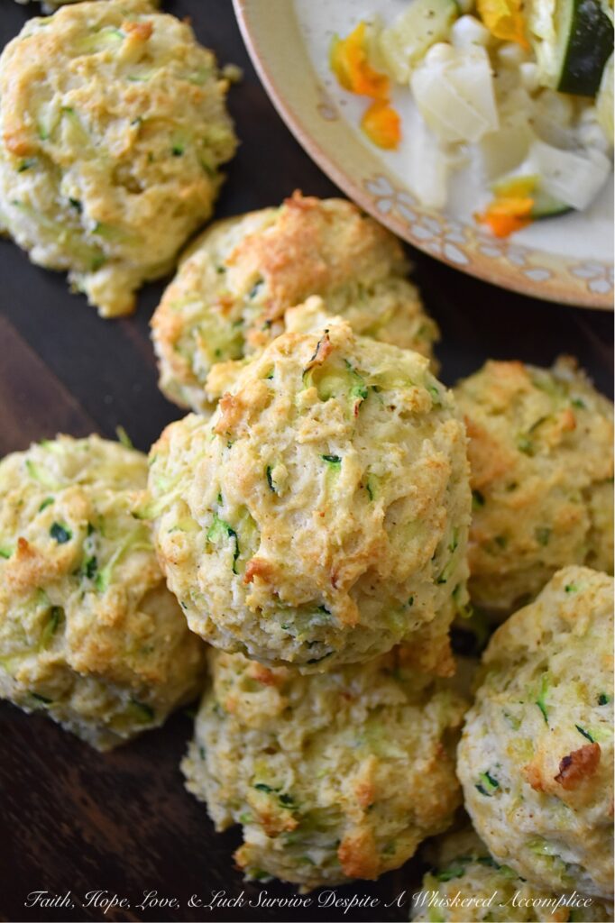 Savory Zucchini Drop Biscuits - With zucchini in season, these buttery, easy-to-make drop biscuits make a delicious addition to any summer meal. The result is a delicious, light, and savory biscuit that pairs perfectly with various dishes. Serve them as a side to your favorite summer soups or salads, or enjoy them as a snack with a pat of rich creamy butter. Whatever way you choose, savory zucchini drop biscuits will make your summer meals all the more special.
