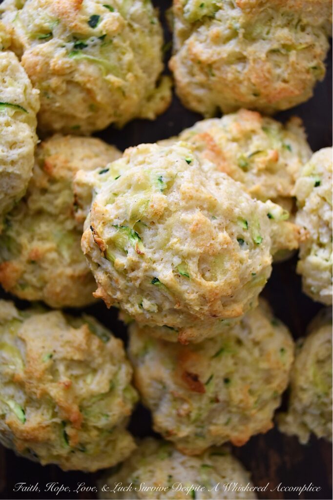 Savory Zucchini Drop Biscuits - With zucchini in season, these buttery, easy-to-make drop biscuits make a delicious addition to any summer meal. The result is a delicious, light, and savory biscuit that pairs perfectly with various dishes. Serve them as a side to your favorite summer soups or salads, or enjoy them as a snack with a pat of rich creamy butter. Whatever way you choose, savory zucchini drop biscuits will make your summer meals all the more special.