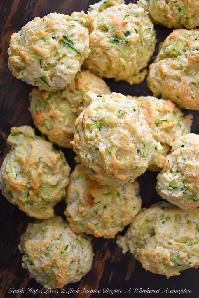 Savory Zucchini Drop Biscuits - With zucchini in season, these buttery, easy-to-make drop biscuits make a delicious addition to any summer meal. The result is a delicious, light, and savory biscuit that pairs perfectly with various dishes. Serve them as a side to your favorite summer soups or salads, or enjoy them as a snack with a pat of rich creamy butter. Whatever way you choose, savory zucchini drop biscuits will make your summer meals all the more special.