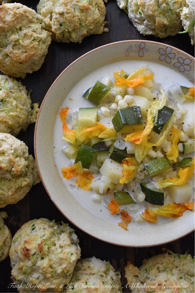 Summer Zucchini Blossom Soup - This super-simple fresh summer soup is the perfect way to take advantage of all the seasonal produce that summer has to offer. Made with zucchini, white corn, yellow onion, and potato, and then garnished with fresh zucchini blossoms, this summertime soup is as stunning as it is delicious. A touch of heavy whipping cream is also included to add a little bit of richness and flavor without making the soup too heavy. Don't be surprised if you find yourself making this summer vegetable soup over and over again.