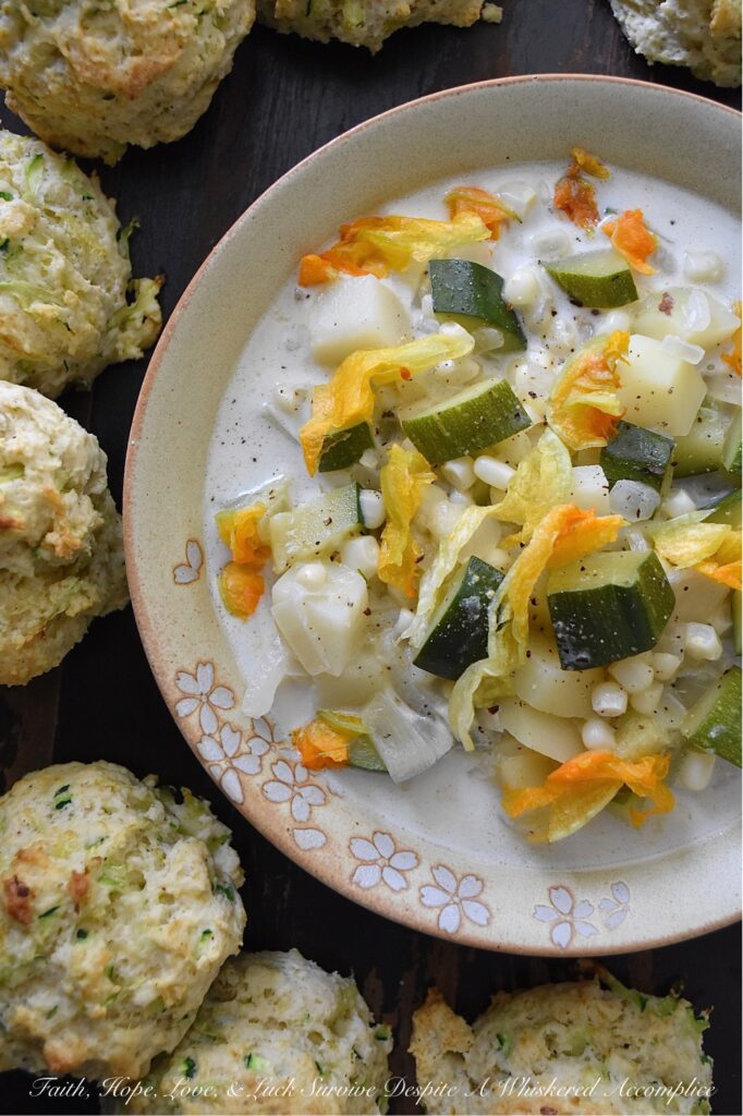 Summer Zucchini Blossom Soup - This super-simple fresh summer soup is the perfect way to take advantage of all the seasonal produce that summer has to offer. Made with zucchini, white corn, yellow onion, and potato, and then garnished with fresh zucchini blossoms, this summertime soup is as stunning as it is delicious. A touch of heavy whipping cream is also included to add a little bit of richness and flavor without making the soup too heavy. Don't be surprised if you find yourself making this summer vegetable soup over and over again.