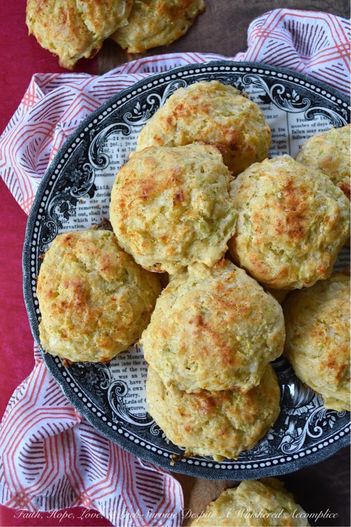 Green Tomato & Cheddar Drop Biscuits - These savory summer drop biscuits are easy to make and require no kneading or rolling. Made with grated green tomato and shredded white cheddar cheese, these biscuits are mildly sweet, cheesy, and full of flavor. They're also seasoned with paprika and melted butter, which gives them a lovely golden appearance and a nice, crispy texture. Summer won't last forever, so make sure to bake up a batch of these biscuits before all of this year's green tomatoes disappear.