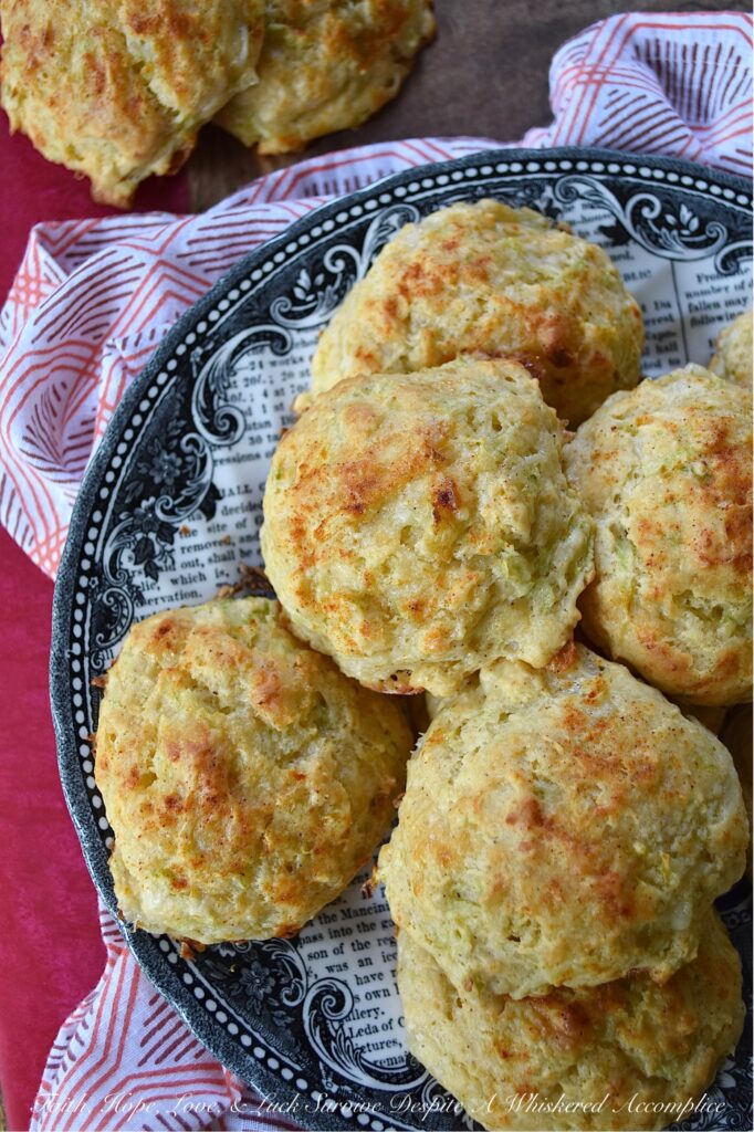 Green Tomato & Cheddar Drop Biscuits - These savory summer drop biscuits are easy to make and require no kneading or rolling. Made with grated green tomato and shredded white cheddar cheese, these biscuits are mildly sweet, cheesy, and full of flavor. They're also seasoned with paprika and melted butter, which gives them a lovely golden appearance and a nice, crispy texture. Summer won't last forever, so make sure to bake up a batch of these biscuits before all of this year's green tomatoes disappear.