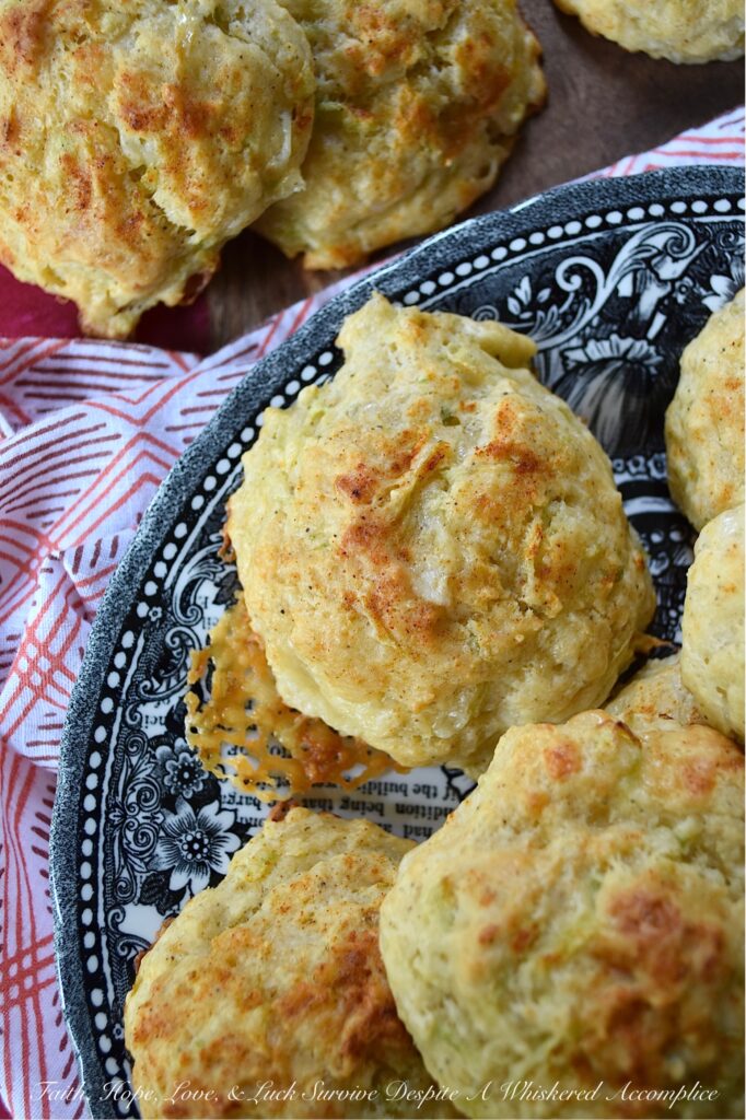 Green Tomato & Cheddar Drop Biscuits - These savory summer drop biscuits are easy to make and require no kneading or rolling. Made with grated green tomato and shredded white cheddar cheese, these biscuits are mildly sweet, cheesy, and full of flavor. They're also seasoned with paprika and melted butter, which gives them a lovely golden appearance and a nice, crispy texture. Summer won't last forever, so make sure to bake up a batch of these biscuits before all of this year's green tomatoes disappear.