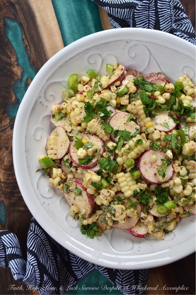 Smoky Cilantro Creamy Corn & Radish Salad - The combination of flavors and textures in this creamy corn and radish vegetable salad is simply delicious. The smoky chili and cumin spices in the creamy mayonnaise-based cilantro dressing give this salad a nice kick, while the corn's sweetness and the sliced radishes' crunch provide a perfect flavor balance. This is a must-try summer vegetable side dish for when you're craving something fresh and flavorful, with a delightful crunchy texture.