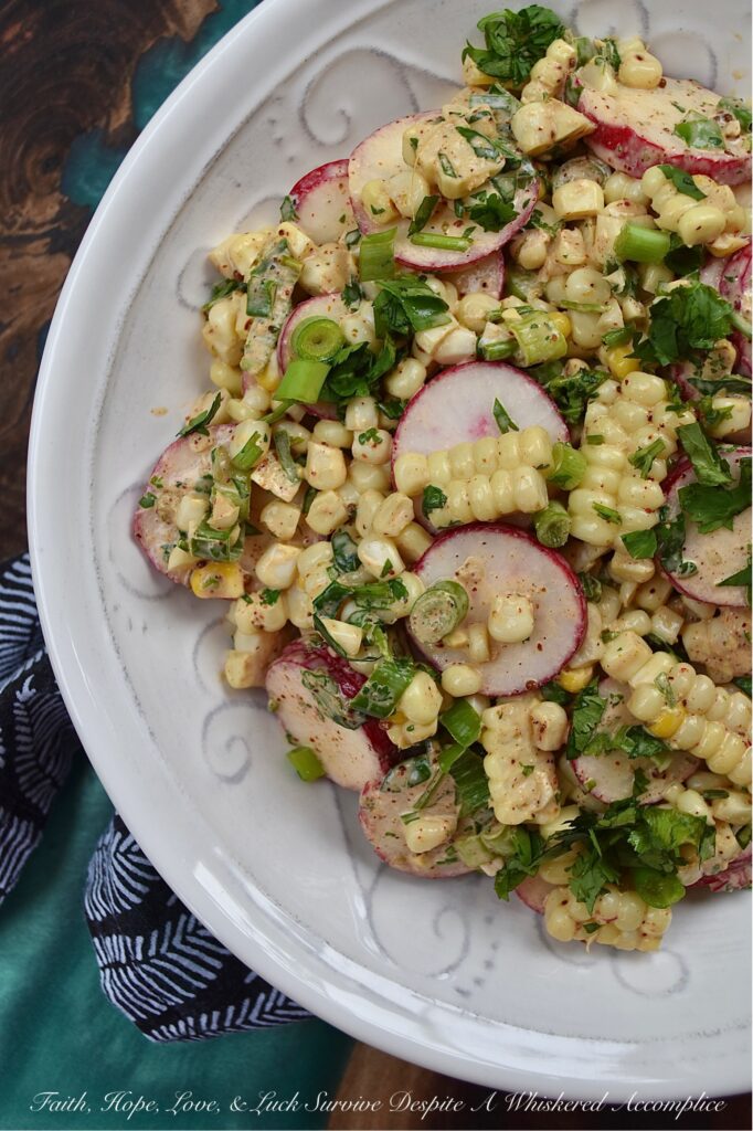 Smoky Cilantro Creamy Corn & Radish Salad - The combination of flavors and textures in this creamy corn and radish vegetable salad is simply delicious. The smoky chili and cumin spices in the creamy mayonnaise-based cilantro dressing give this salad a nice kick, while the corn's sweetness and the sliced radishes' crunch provide a perfect flavor balance. This is a must-try summer vegetable side dish for when you're craving something fresh and flavorful, with a delightful crunchy texture.
