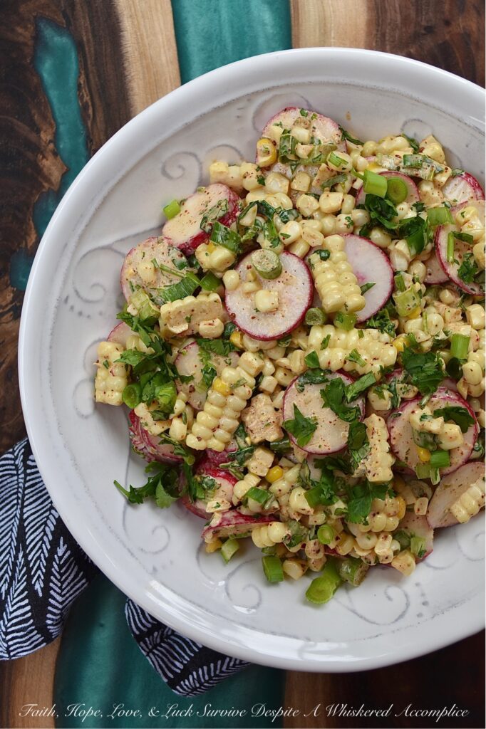 Smoky Cilantro Creamy Corn & Radish Salad - The combination of flavors and textures in this creamy corn and radish vegetable salad is simply delicious. The smoky chili and cumin spices in the creamy mayonnaise-based cilantro dressing give this salad a nice kick, while the corn's sweetness and the sliced radishes' crunch provide a perfect flavor balance. This is a must-try summer vegetable side dish for when you're craving something fresh and flavorful, with a delightful crunchy texture.