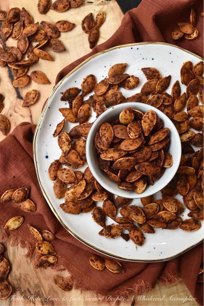 Buttery Chili Roasted Pumpkin Seeds - Fall is the perfect time of year to enjoy a seasonal snack with a hint of salt and a slightly spicy chili kick, so make sure you don't throw away your pumpkin seeds after you carve your pumpkins this year. After these pumpkin seeds are boiled in salted water they are then oven-roasted with melted butter, chili powder, and onion powder. Once they're finished baking, sprinkle the roasted pumpkin seeds with a bit of sea salt for the perfect savory nibble. Enjoy these pumpkin seeds as a snack during the fall months, or use them to garnish a comforting bowl of pumpkin soup or a fresh garden salad topped with dried cranberries and diced apples.