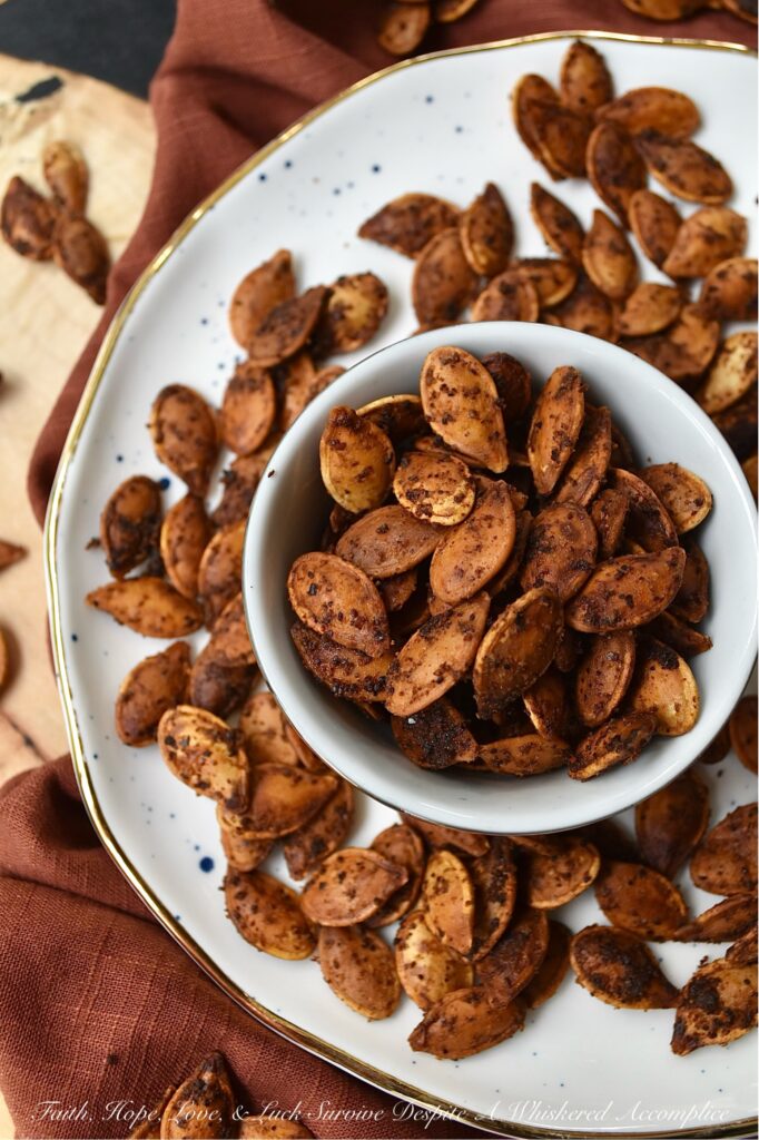 Buttery Chili Roasted Pumpkin Seeds - Fall is the perfect time of year to enjoy a seasonal snack with a hint of salt and a slightly spicy chili kick, so make sure you don't throw away your pumpkin seeds after you carve your pumpkins this year. After these pumpkin seeds are boiled in salted water they are then oven-roasted with melted butter, chili powder, and onion powder. Once they're finished baking, sprinkle the roasted pumpkin seeds with a bit of sea salt for the perfect savory nibble. Enjoy these pumpkin seeds as a snack during the fall months, or use them to garnish a comforting bowl of pumpkin soup or a fresh garden salad topped with dried cranberries and diced apples.