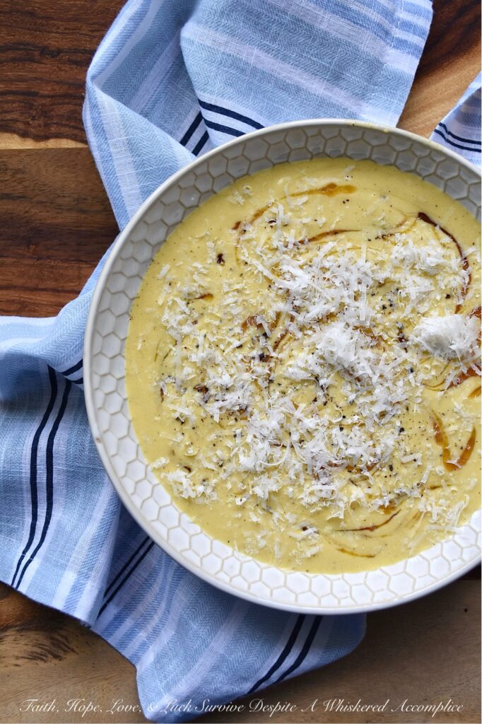 Parmesan Pumpkin Soup with Hot Honey - Parmesan Pumpkin Soup with Hot Honey is the perfect fall soup to warm you up on a chilly autumn night. Start by peeling and cubing fresh pumpkin and simmering it in a stockpot with chicken broth and seasonings until the pumpkin is tender. Once the pumpkin has cooked, add some freshly grated parmesan, half and half, and heavy whipping cream. Purée the soup until smooth and creamy, then ladle it into bowls. Top each bowl with a drizzle of honey infused with chiles for a hint of heat, and then sprinkle on some freshly grated parmesan cheese for a salty, nutty flavor.