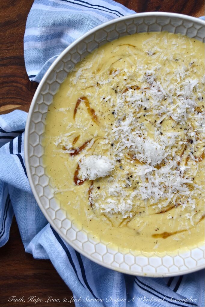 Parmesan Pumpkin Soup with Hot Honey - Parmesan Pumpkin Soup with Hot Honey is the perfect fall soup to warm you up on a chilly autumn night. Start by peeling and cubing fresh pumpkin and simmering it in a stockpot with chicken broth and seasonings until the pumpkin is tender. Once the pumpkin has cooked, add some freshly grated parmesan, half and half, and heavy whipping cream. Purée the soup until smooth and creamy, then ladle it into bowls. Top each bowl with a drizzle of honey infused with chiles for a hint of heat, and then sprinkle on some freshly grated parmesan cheese for a salty, nutty flavor.