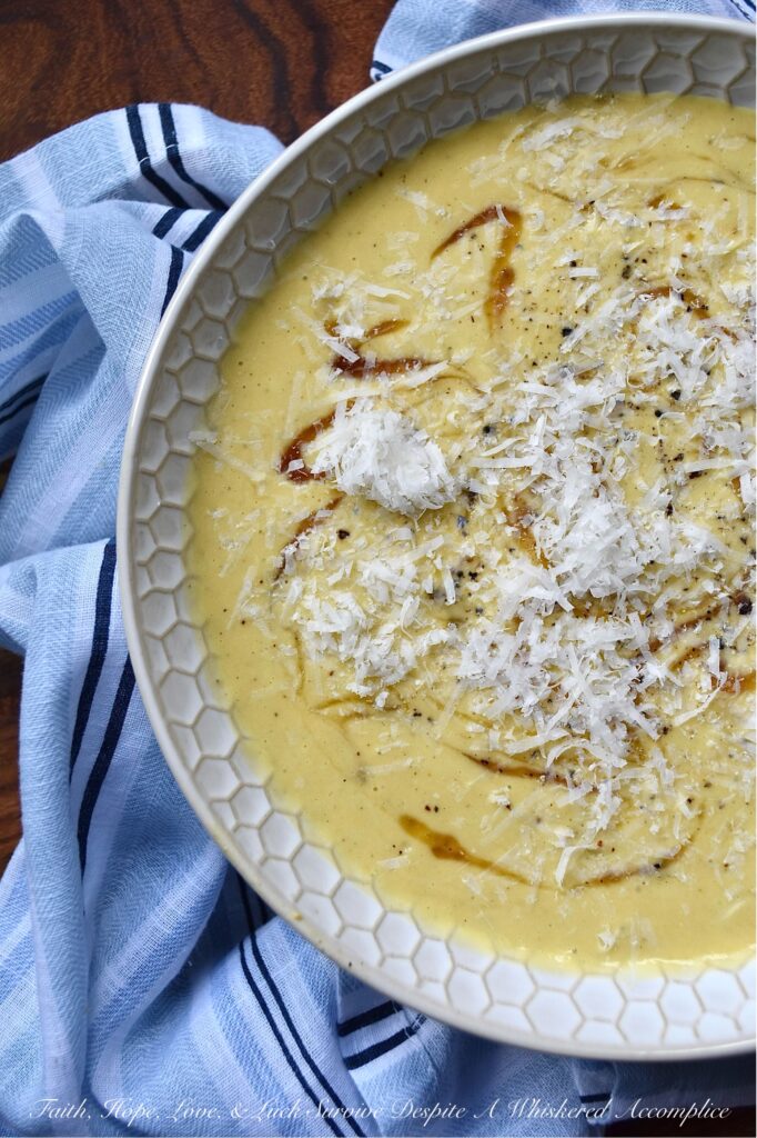 Parmesan Pumpkin Soup with Hot Honey - Parmesan Pumpkin Soup with Hot Honey is the perfect fall soup to warm you up on a chilly autumn night. Start by peeling and cubing fresh pumpkin and simmering it in a stockpot with chicken broth and seasonings until the pumpkin is tender. Once the pumpkin has cooked, add some freshly grated parmesan, half and half, and heavy whipping cream. Purée the soup until smooth and creamy, then ladle it into bowls. Top each bowl with a drizzle of honey infused with chiles for a hint of heat, and then sprinkle on some freshly grated parmesan cheese for a salty, nutty flavor.