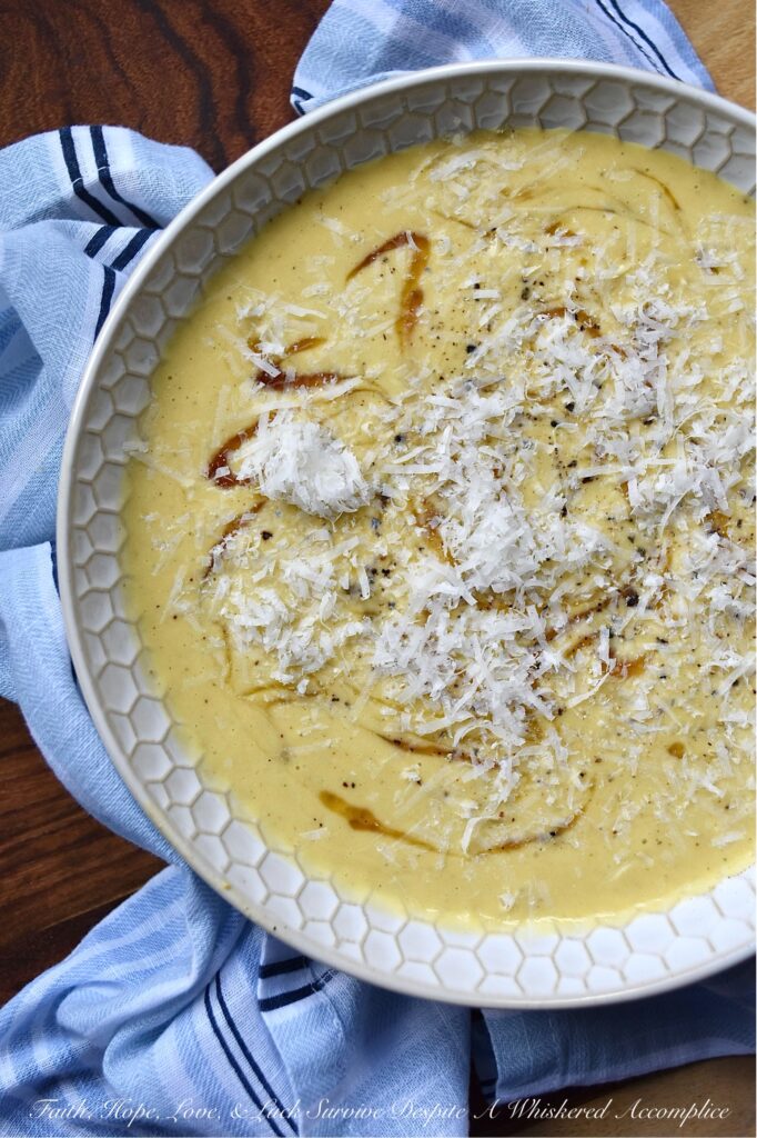 Parmesan Pumpkin Soup with Hot Honey - Parmesan Pumpkin Soup with Hot Honey is the perfect fall soup to warm you up on a chilly autumn night. Start by peeling and cubing fresh pumpkin and simmering it in a stockpot with chicken broth and seasonings until the pumpkin is tender. Once the pumpkin has cooked, add some freshly grated parmesan, half and half, and heavy whipping cream. Purée the soup until smooth and creamy, then ladle it into bowls. Top each bowl with a drizzle of honey infused with chiles for a hint of heat, and then sprinkle on some freshly grated parmesan cheese for a salty, nutty flavor.