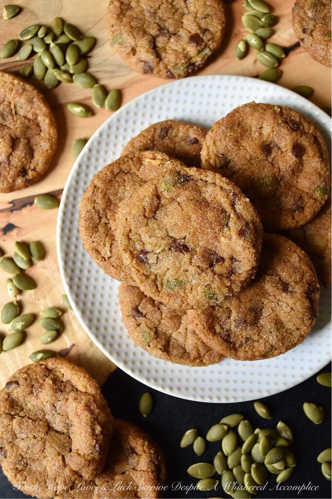 Cinnamon Sugar Pumpkin Crackle Cookies - When it comes to fall, there's nothing quite like a delicious warm batch of chocolate chip pumpkin cookies. These delightfully delicious cookies are filled with miniature chocolate chips and roasted salted pumpkin seeds or pepitas, and then covered in a delightful crunchy cinnamon sugar coating. The result is a seasonal crackle cookie that is soft and chewy on the inside, yet crispy and full of texture on the outside.