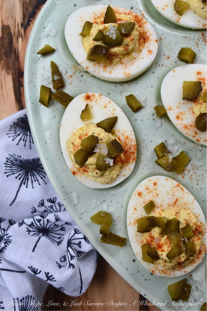 Southern Sweet Pickle Deviled Eggs - Southern sweet pickle deviled eggs are a great choice for any occasion, whether you're in need of a quick snack, a side dish, or perhaps an appetizer to start off a meal. The combination of mayonnaise, pickle juice, and dry mustard creates a tangy and savory flavor that is perfectly balanced with a touch of sweetness. And, the garnish of diced sweet pickle, paprika, and flaky sea salt adds just the right hint of flavorful salty sweetness to make these deviled eggs absolutely irresistible.