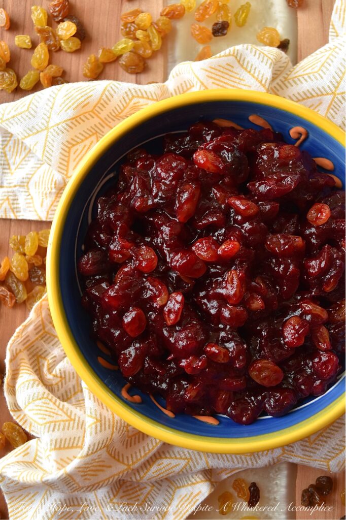 Rum Raisin Whole Berry Cranberry Sauce - This homemade whole berry cranberry sauce is the perfect holiday side dish. Made with fresh cranberries, golden raisins, spiced rum, granulated sugar, light brown sugar, and a touch of cinnamon, sea salt, and vanilla, this rum-raisin-flavored cranberry sauce adds a special touch to any holiday meal. The tartness of the cranberries, the sweetness of the sugars, and the spiciness of the rum all come together to make a delicious and unique cranberry sauce that will be a hit with your holiday guests.