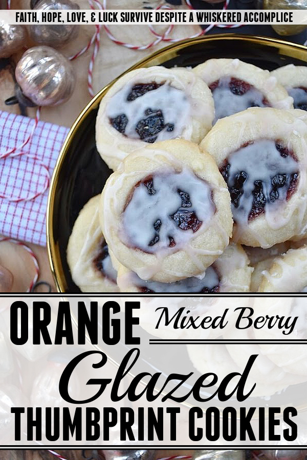 Orange Mixed Berry Glazed Thumbprint Cookies - These gorgeous mixed berry preserves-filled orange thumbprint cookies, topped with a simple orange and vanilla extract powdered glaze, are a delicious treat that combines buttery, sweet, citrusy, and fruity flavors to create a cookie worthy of any cookie tray or platter. Whether you bake these cookies during the holidays or just because you’re craving something sweet, they're guaranteed to be an instant hit with anyone who tries them.