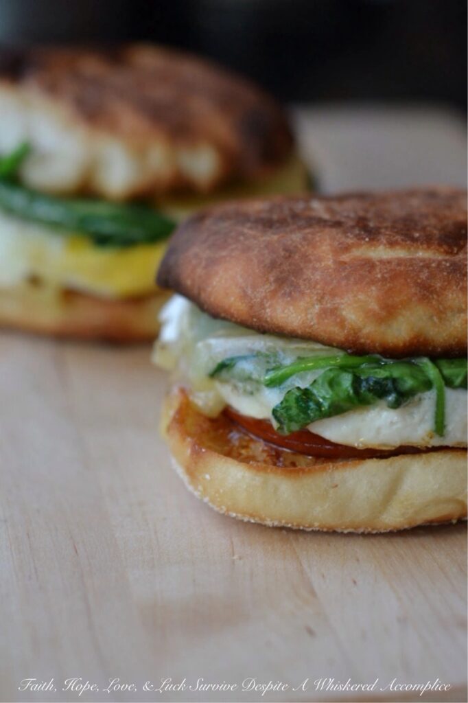 Fig and Brie Breakfast Sandwiches - This is no ordinary bacon, egg, and cheese sandwich recipe, these sandwiches take things to a whole new level. It all starts with perfectly toasted English muffins, slathered with a generous amount of fig jam or preserves. Next comes Canadian bacon, perfectly fried eggs, a handful of fresh spinach leaves, and a generous amount of melted brie cheese. This is the type of sandwich you won't mind waking up early for.