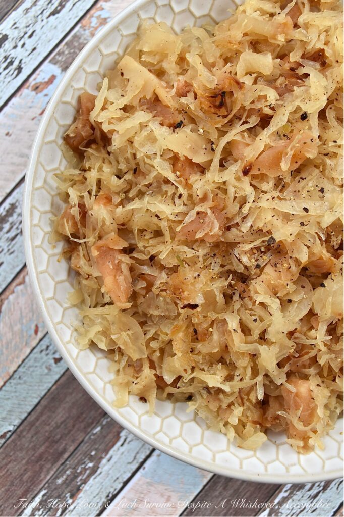 Dried Apple & Bourbon Oven-Baked Sauerkraut - This Dried Apple & Bourbon Oven-Baked Sauerkraut is a simple yet delicious side dish that combines the tanginess of sauerkraut with the sweetness of dried apples and brown sugar plus the bold and smoky flavor of bourbon. It's the perfect side dish to add some variety to your meals and is sure to be a crowd-pleaser for any game day, cookout, or holiday gathering. If you're looking for a new way to enjoy sauerkraut, be prepared to be blown away by this delicious sweet and tangy version.