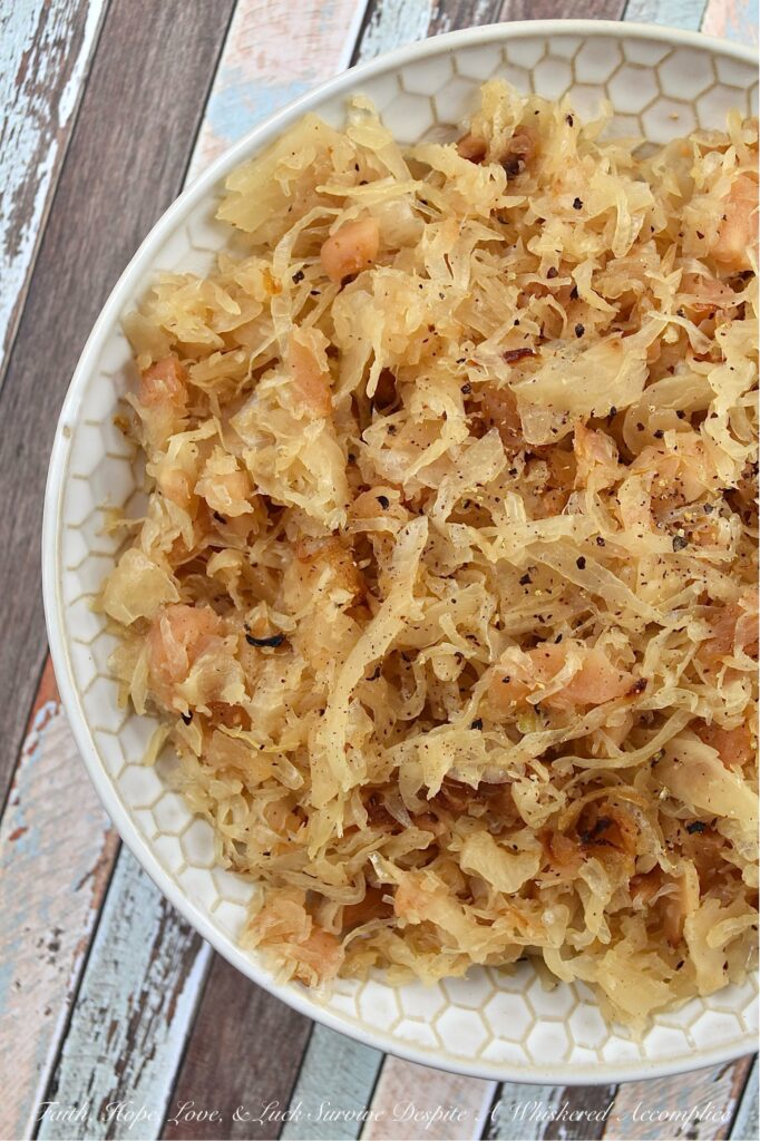 Dried Apple & Bourbon Oven-Baked Sauerkraut - This Dried Apple & Bourbon Oven-Baked Sauerkraut is a simple yet delicious side dish that combines the tanginess of sauerkraut with the sweetness of dried apples and brown sugar plus the bold and smoky flavor of bourbon. It's the perfect side dish to add some variety to your meals and is sure to be a crowd-pleaser for any game day, cookout, or holiday gathering. If you're looking for a new way to enjoy sauerkraut, be prepared to be blown away by this delicious sweet and tangy version.