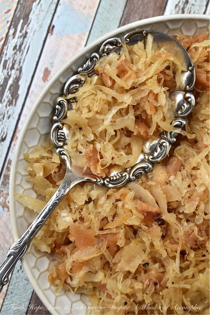 Dried Apple & Bourbon Oven-Baked Sauerkraut - This Dried Apple & Bourbon Oven-Baked Sauerkraut is a simple yet delicious side dish that combines the tanginess of sauerkraut with the sweetness of dried apples and brown sugar plus the bold and smoky flavor of bourbon. It's the perfect side dish to add some variety to your meals and is sure to be a crowd-pleaser for any game day, cookout, or holiday gathering. If you're looking for a new way to enjoy sauerkraut, be prepared to be blown away by this delicious sweet and tangy version.