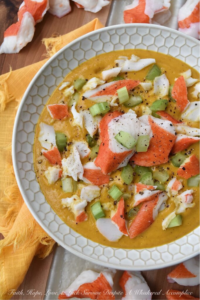Creamy Cajun Sweet Potato Soup with Crab - Are you looking for a new and exciting twist on a traditional sweet potato soup recipe? Look no further than this Creamy Cajun Sweet Potato Soup with Crab. This delicious soup is bursting with flavor, thanks to a homemade seasoning blend that adds a spicy Cajun kick to its creamy sweet potato base. Topped with imitation crab meat and crunchy diced celery, this soup is sure to become a new spicy weeknight favorite.